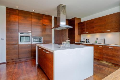a kitchen with wooden cabinets and a white counter top at Stars View by Portugal Active in Fafe