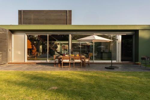 a dining table with an umbrella on a patio at Stars View by Portugal Active in Fafe