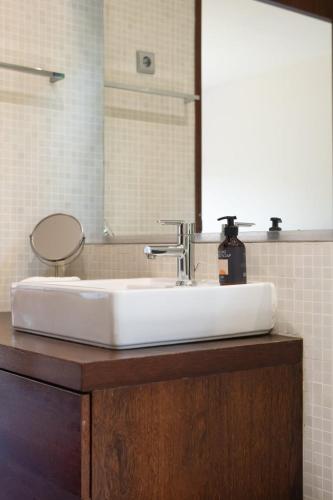 a bathroom with a white sink and a mirror at Stars View by Portugal Active in Fafe
