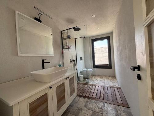 a bathroom with a sink and a mirror and a toilet at Villa with Pool & View in Bitez in Bodrum City