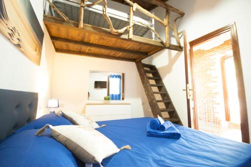a bedroom with a blue bed in a room at B&B Sinis Domus in Siniscola