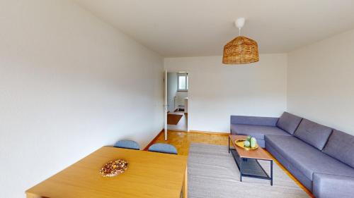 un soggiorno con un divano e un tavolo di Basic & Simple on Langgrütstrasse a Zurigo