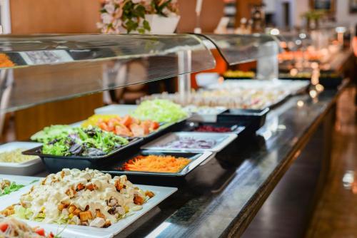 a buffet line with many different types of food at Hotel Alba Seleqtta in Lloret de Mar