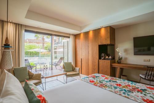 a hotel room with a bed and a view of a patio at Kube Saint-Tropez in Saint-Tropez