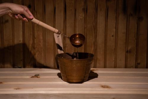 a person is stirring a cup with a spoon at Hotel Alba Seleqtta in Lloret de Mar