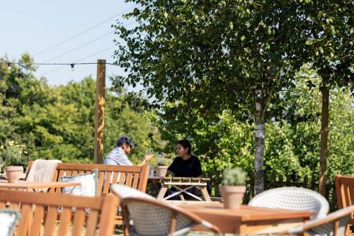 two women sitting at a table in a garden at The Hampshire Hog in Clanfield