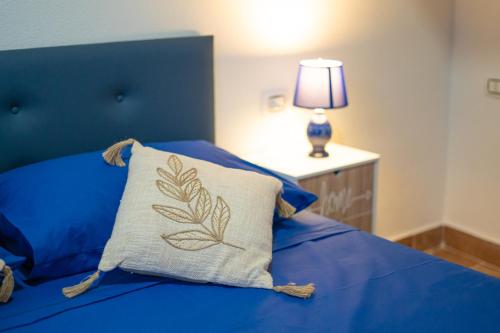 a blue bed with a pillow on top of it at B&B Sinis Domus in Siniscola