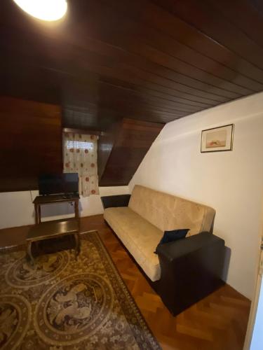 a living room with a couch and a tv at Lana in Cetinje