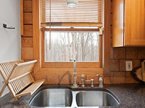 a sink in a kitchen with a window at 5 min to Lake Chic Cozy Hot Tub in Sparta