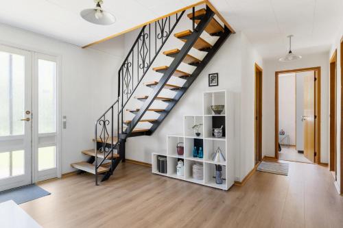 a staircase in a living room with wooden floors at Quiet villa apartment close to everything in Odense
