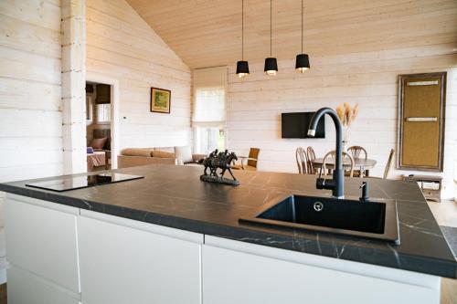 a kitchen with a black counter top and a sink at Royal Horse Resort in Balkasodis