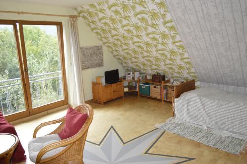 a living room with a bed and a window at Ferienhaus Ahler Kopf in Lahnstein