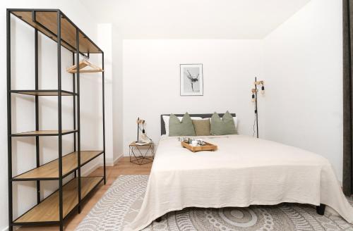 a bedroom with a bed and a book shelf at Modernes 3-Zimmer-Apartment - nähe Krankenhaus, Altstadt, Bahnhof - Parken in Amberg