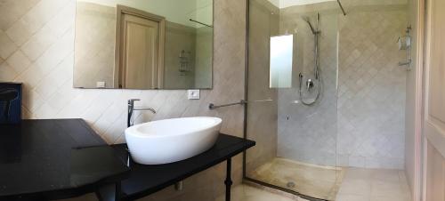 a bathroom with a sink and a shower at Villa Florida 1 with private pool in San Teodoro