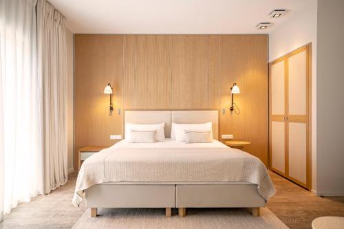a bedroom with a bed with two tables and two lamps at Kube Saint-Tropez in Saint-Tropez