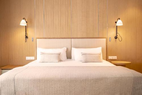 a bedroom with a large white bed with two pillows at Kube Saint-Tropez in Saint-Tropez