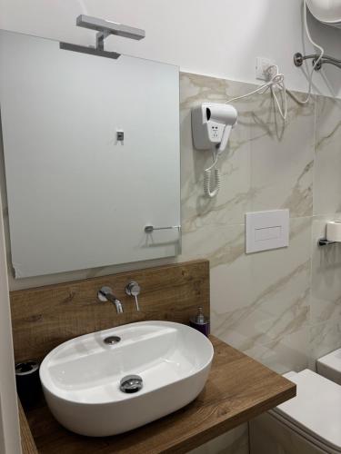 a bathroom with a white sink and a mirror at Il dipinto in Reggio Calabria