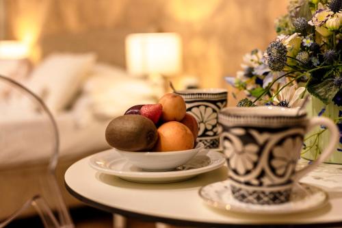 a bowl of fruit on a table in a room at Albergo La Rocca in Brisighella