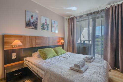 Ένα ή περισσότερα κρεβάτια σε δωμάτιο στο Apartamenty Na Klifie Q4 Apartments