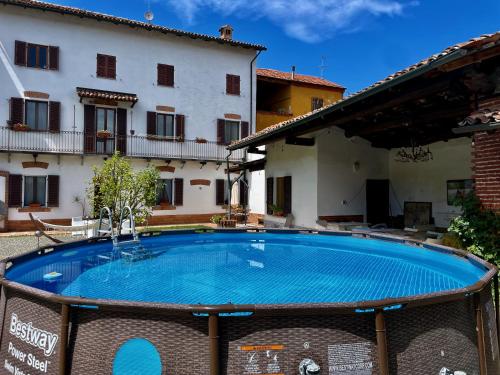 a large swimming pool in front of a building at Casa Pierre in Castelnuovo Bormida