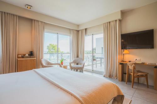 a hotel room with a bed and a desk with a computer at Kube Saint-Tropez in Saint-Tropez