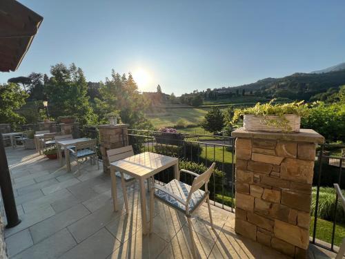 a patio with a table and chairs and a view at Bes Hotel Terme a Palazzago in Palazzago