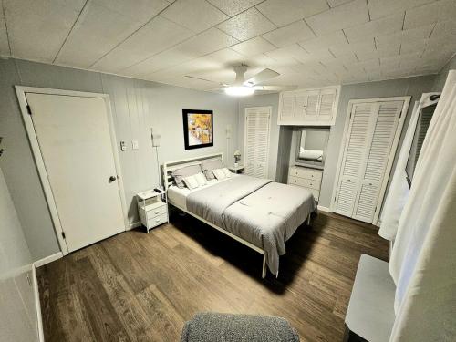 a bedroom with a large bed and white shutters at Super Comfy Entire Home in Scranton