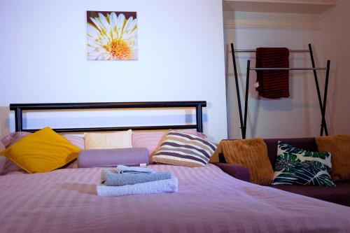a bedroom with a bed with colorful pillows at Edinburgh Road Guest House in Liverpool