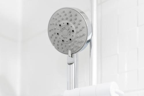 a shower head hanging on a wall at Stylish Apartment - Wolverhampton City Centre - High-Speed Internet 12AC in Wolverhampton