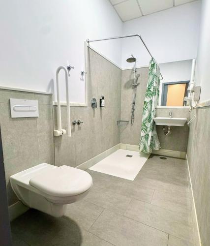 a bathroom with a toilet and a shower and a sink at IVY HOUSE in Seville