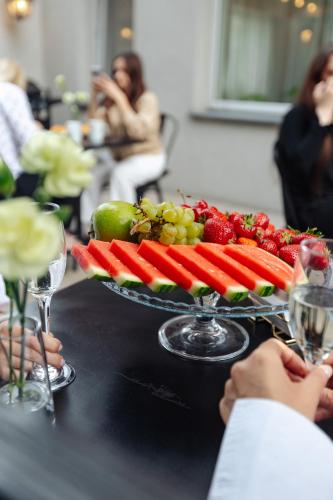 a tray of fruit and vegetables on a table at Hotel Victory Home in Warsaw