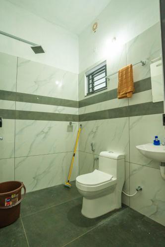 a bathroom with a white toilet and a sink at riverview homestay in Cochin