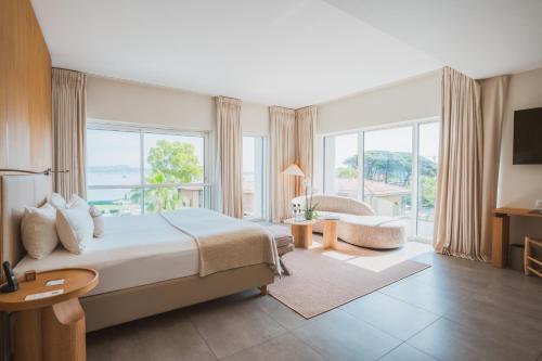 a hotel room with a bed and a large window at Kube Saint-Tropez in Saint-Tropez