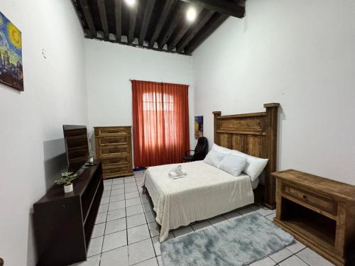 a bedroom with a bed and a table and a window at Hostal puebla in San Baltasar