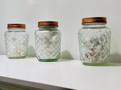 three glass jars sitting on top of a shelf at GL- Great Location, Free Parking, Spacious, Private Office & Family Friendly in Evanston
