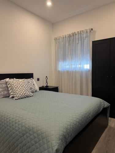 a bedroom with a bed and a window at Beach Luxury Apartment in Praia de Mira