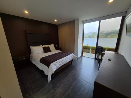 a bedroom with a large bed and a large window at Casa el OLIVO in Club Las Anonimos