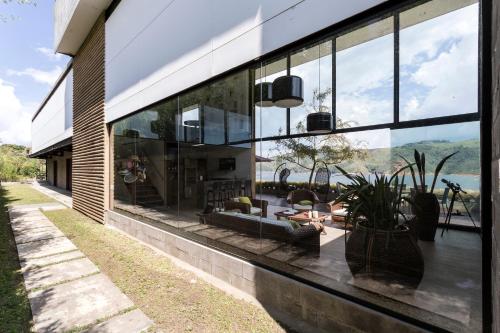 a building with large glass windows and a patio at Casa el OLIVO in Club Las Anonimos