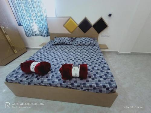 a bed in a room with two pillows on it at Swapnapurti Holiday home in Lonavala