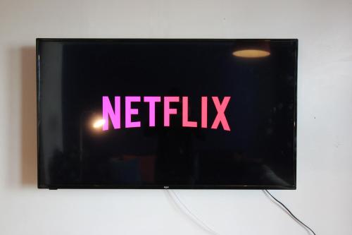 a television with the word netflix on the screen at Central Birmingham Apartment with Balcony & Netflix in Birmingham