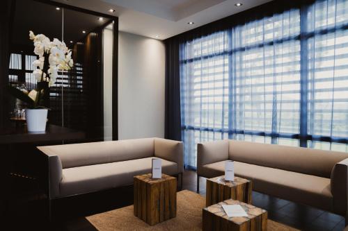 a living room with two couches and two tables at Kube Saint-Tropez in Saint-Tropez