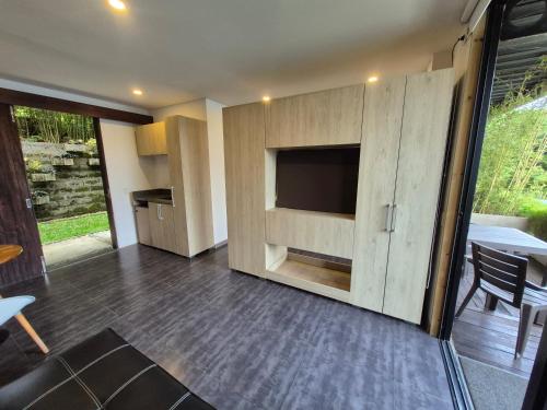 a living room with a tv and a wooden wall at Casa el OLIVO in Club Las Anonimos