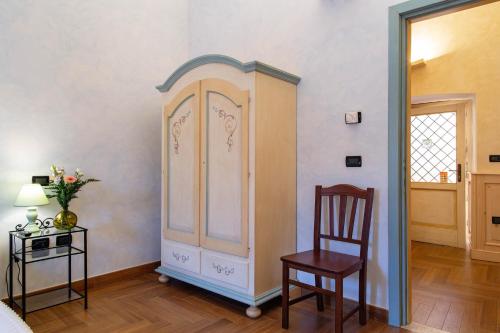 a room with a cabinet and a chair and a table at Palazzo Cappa-Affitti Brevi Italia in LʼAquila