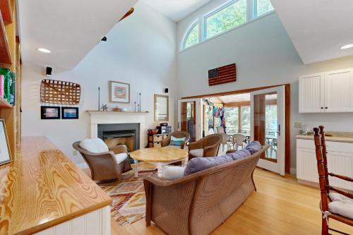 a kitchen and living room with a table and chairs at The Ski Lodge in Ossipee