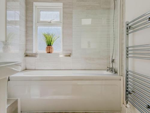 a white bathroom with a tub and a window at 58 Thorpe road - City Centre in Norwich
