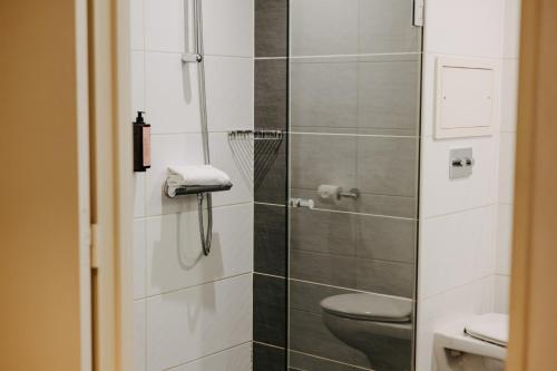 a bathroom with a toilet and a glass shower at Residhome Nanterre La Défense in Nanterre