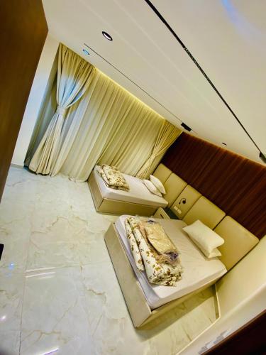 an overhead view of a room with two beds at Luxury 3 bedroom apartment in Banī Ghālib