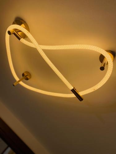 a white rope hanging from a ceiling at Luxury 3 bedroom apartment in Banī Ghālib