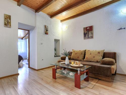 a living room with a couch and a table at Holiday Home Kate by Interhome in Potpićan