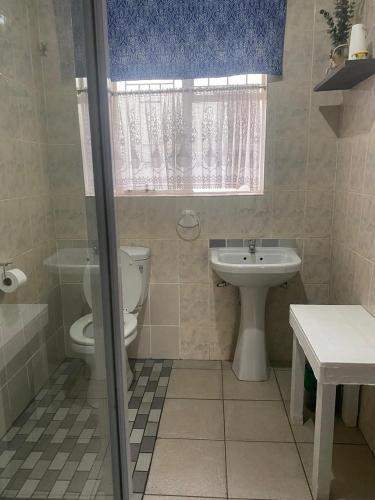 a bathroom with a toilet and a sink at Straebe Stay in Bloemfontein